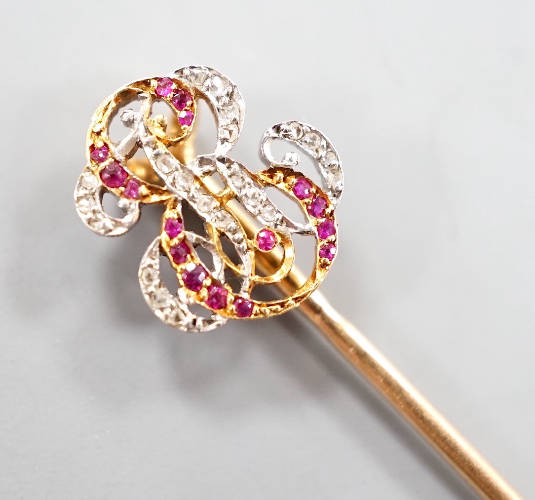 An early 20tyh century French yellow metal (18ct poincon mark) ruby and diamond set 'ER' monogram stick pin, 70mm, gross weight 2 grams, in Sewell of Berkeley Square red leather box.